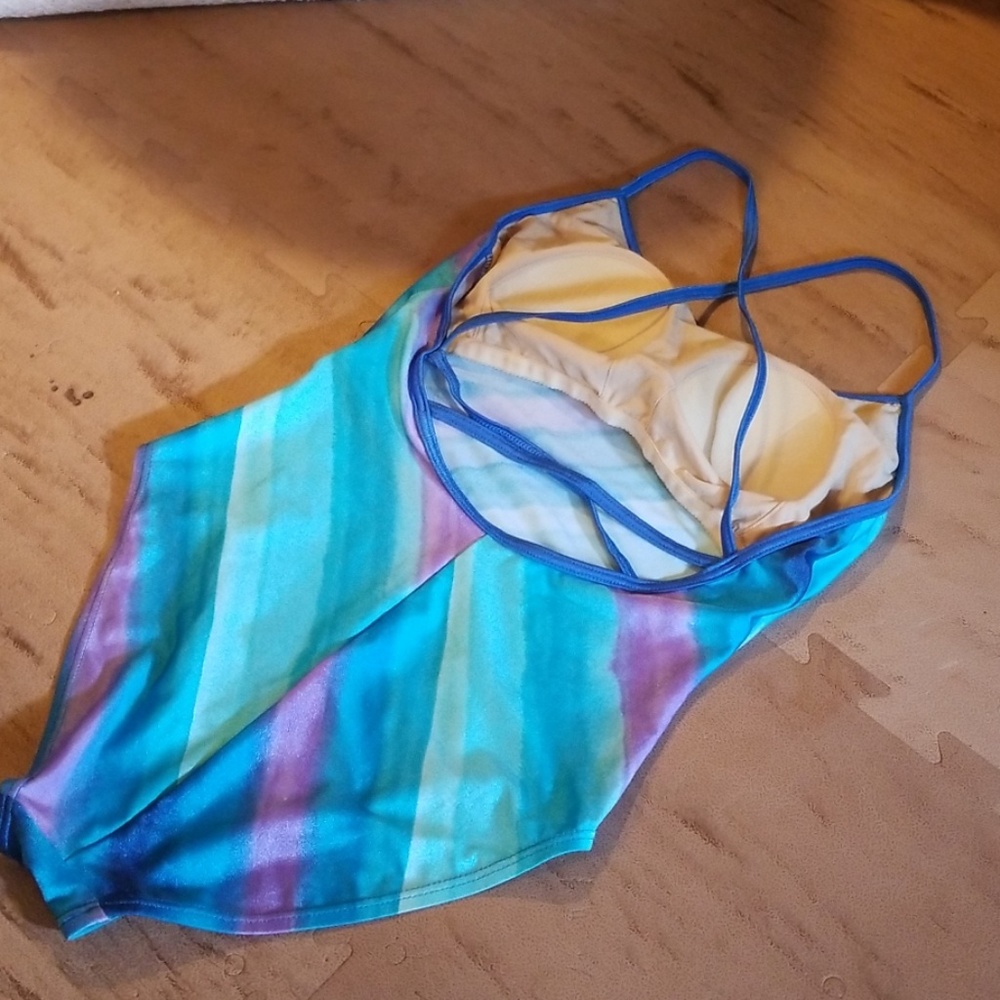 Pastel colored one piece swimsuit that criss cross